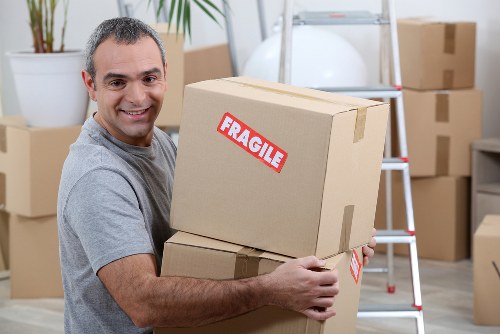 Family home move in Richmond with movers carrying boxes and furniture