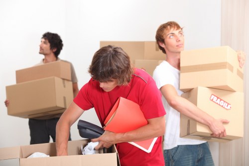 Packed boxes and furniture measured for a removals estimate