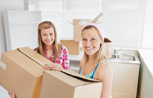 Specialist movers transporting a grand piano through a Richmond property